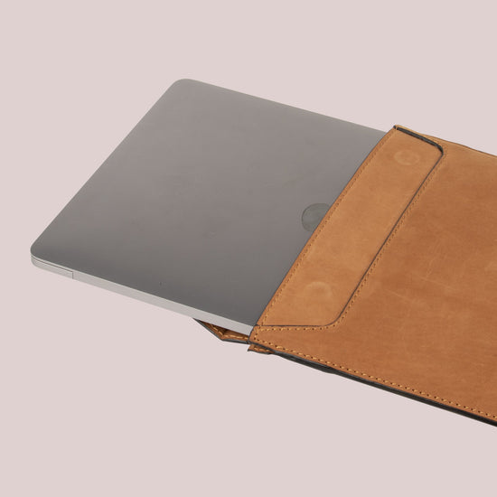 Tan leather sleeve with a flap for Macbook laptops